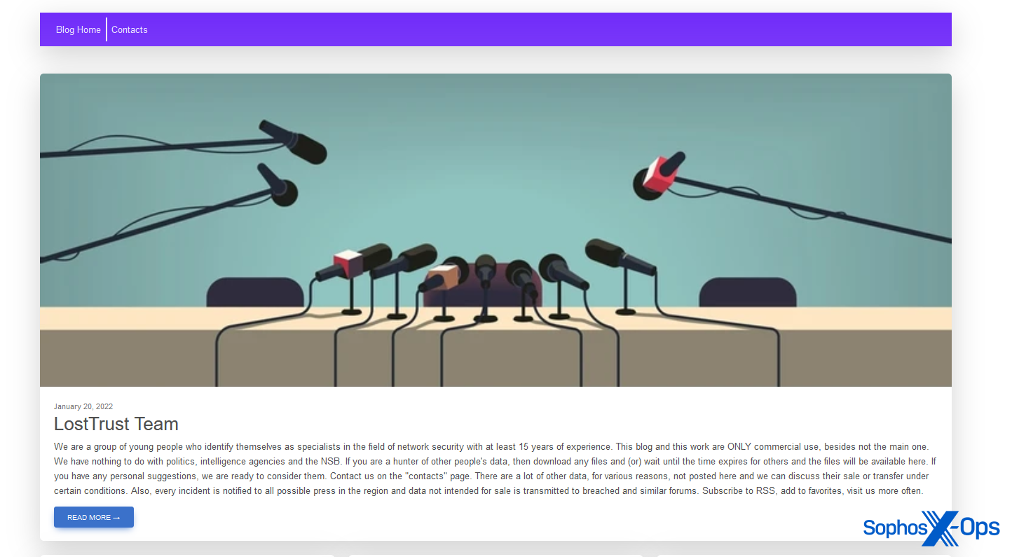 A screenshot of a ransomware leak site. The leak site features a graphic of a long table, three empty chairs, and numerous microphones pointed at the chairs, like a press conference